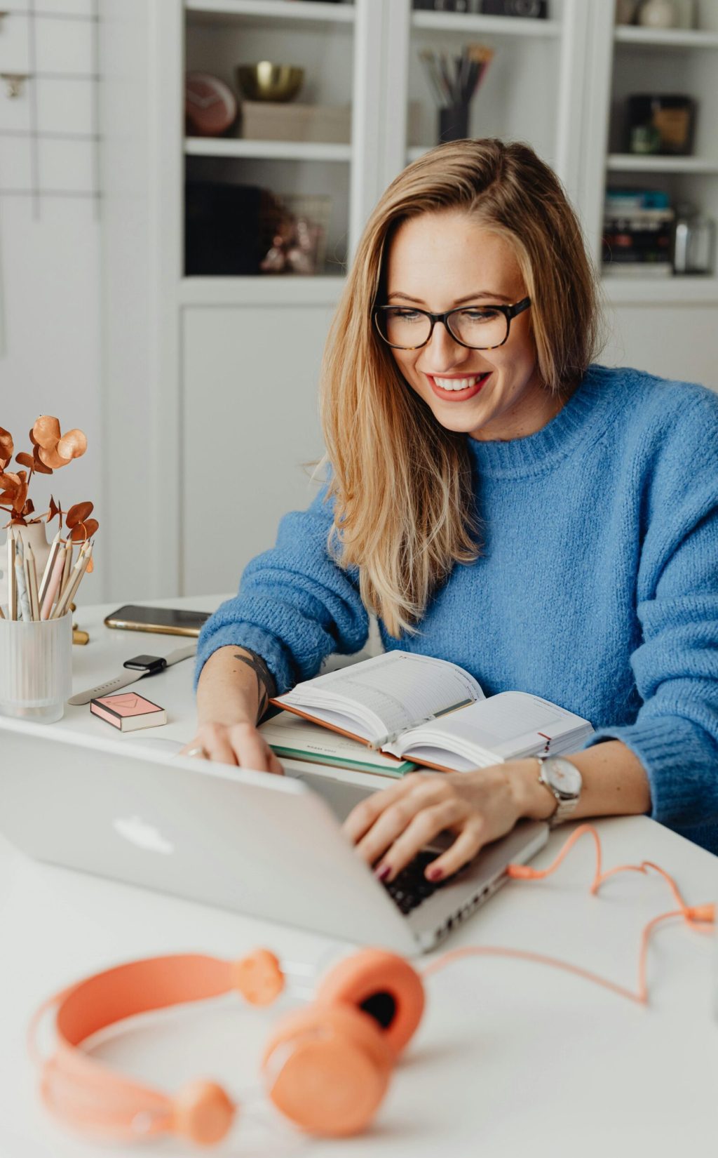 woman with headphones and glasses at laptop-min woman with headphones and glasses at laptop-min